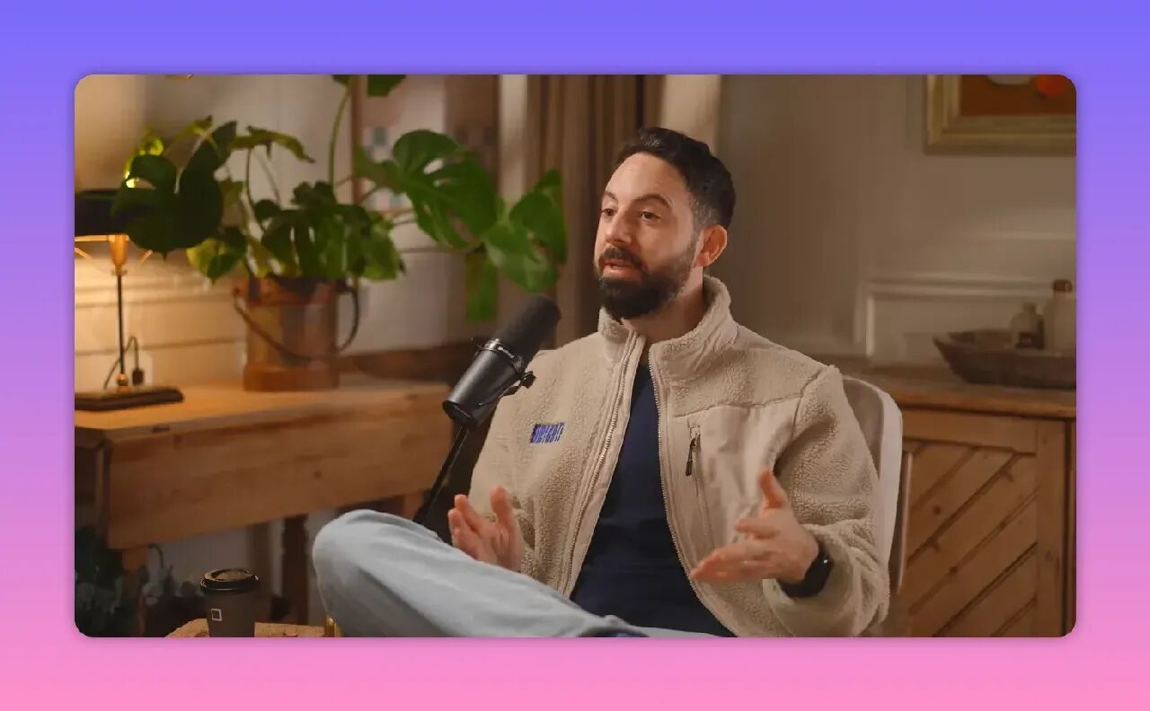 man speaking with open hand gestures into a microphone during an interview, clear and well-lit